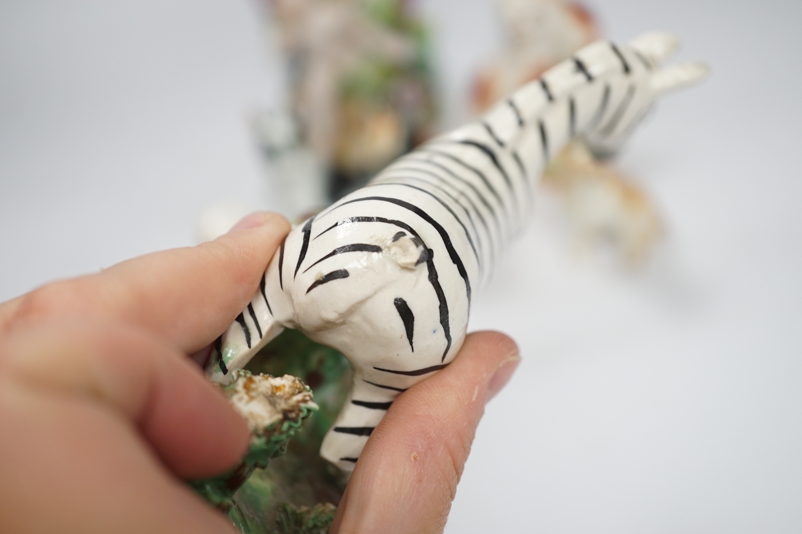 A 19th century Staffordshire zebra and mixed animals and putti ceramics, tallest putti vase 13.5cm high (14)